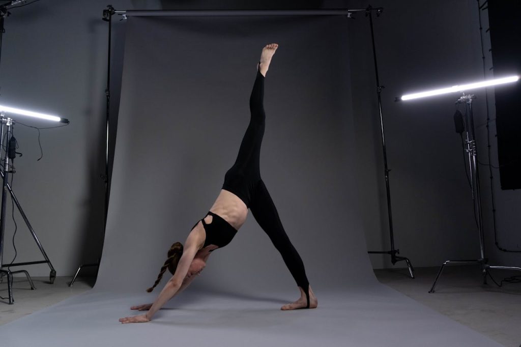Crafting Captivating Headlines: Your awesome post title goes here Adult woman executing yoga pose in professional studio with balanced lighting.
