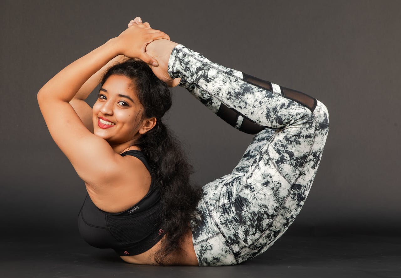 Offerings Woman practicing advanced yoga pose indoors, showcasing flexibility and strength.
